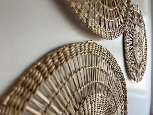a group of wicker baskets hanging on a wall at Nine on Main in Stanley