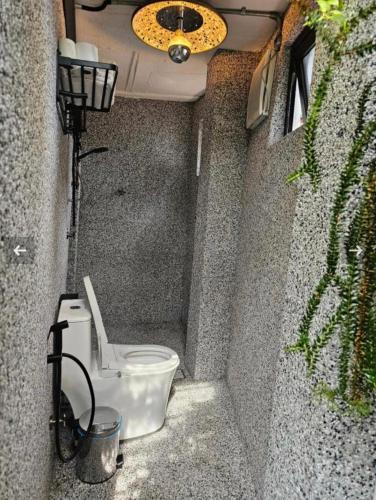a small bathroom with a toilet in a wall at The Opposite Place in Melaka