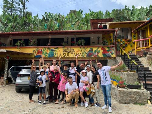 a group of people posing for a picture in front of a house at Hotel La Sultana in Jardin