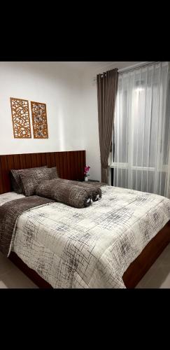 um quarto com uma cama com um gato deitado sobre ela em Villa purnama oro-oro ombo batu em Tlekung