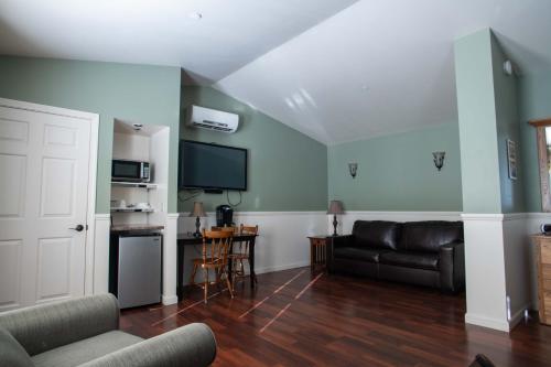 a living room with a couch and a table at Swift River Suites in Rumford