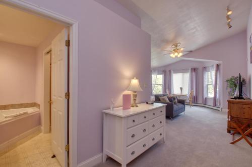 a living room with a white dresser and a bathroom at Castle Creek Manor in Grand Junction