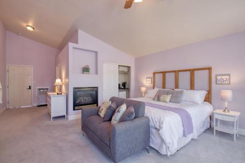 a bedroom with a bed and a couch and a tv at Castle Creek Manor in Grand Junction