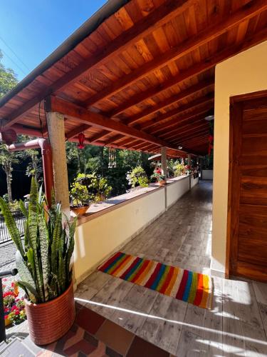 a patio with a wooden pergola and a colorful rug at Hotel La Sultana in Jardin