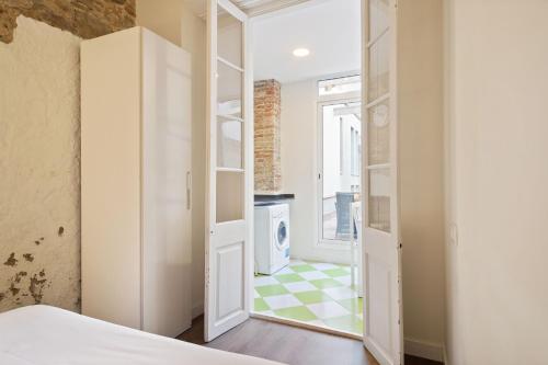 a bedroom with a door open to a laundry room at Stay U-nique Apartments Vila de Gracia II in Barcelona