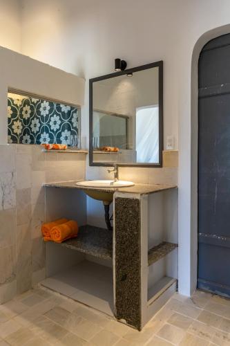 a bathroom with a sink and a mirror at Chilli Fields in Phan Rang–Tháp Chàm
