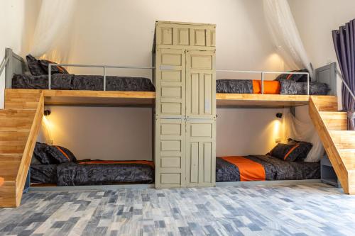 a room with three bunk beds in a room at Chilli Fields in Phan Rang