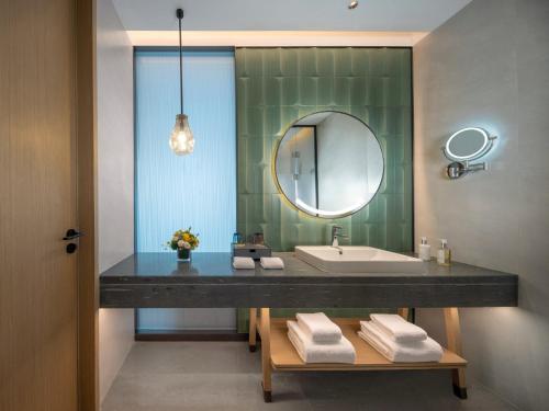 a bathroom with a sink and a mirror at Holiday Inn Chengdu East, an IHG Hotel in Chengdu