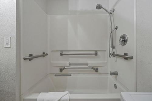 a bathroom with a bath tub and a toilet at I-DRIVE SUITES in Orlando