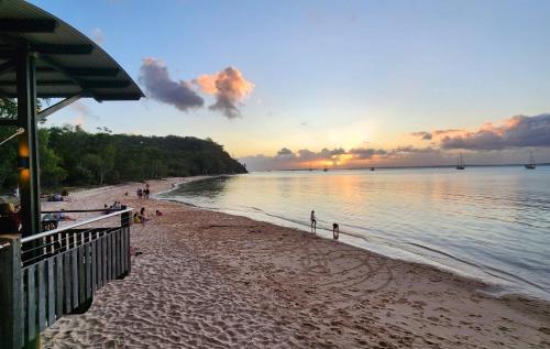 a group of people on a beach at sunset at Fraser Island - Holiday Villa Heaven in K'gari Island (Fraser Island)