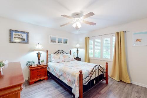 a bedroom with a bed and a ceiling fan at Coastal Dreams in Venice