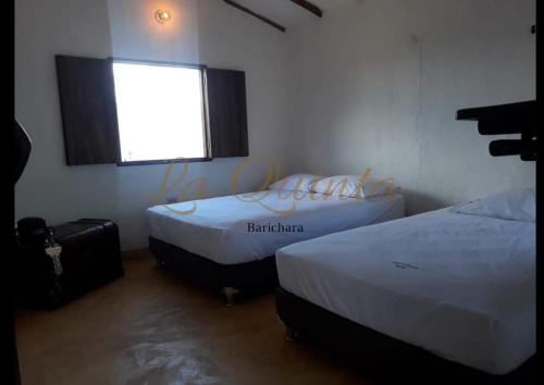 En eller flere senge i et værelse på La Quinta Barichara