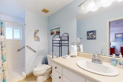 a bathroom with a sink and a toilet and a shower at Coastal Dreams in Venice