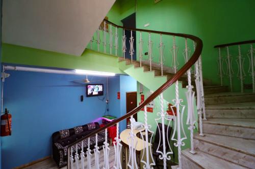 a staircase in a room with blue and green walls at GRG Hotel Wow Inn Kolkata in Salt Lake City