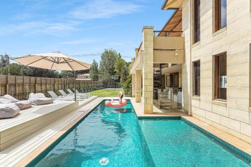 a swimming pool with a red float in a house at The Ultimate Getaway in Portsea