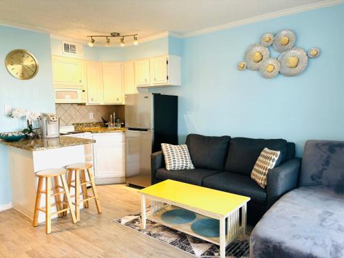 a living room with a couch and a table at Beautiful newly renovated beachfront condo at Casa Del Mars in Galveston