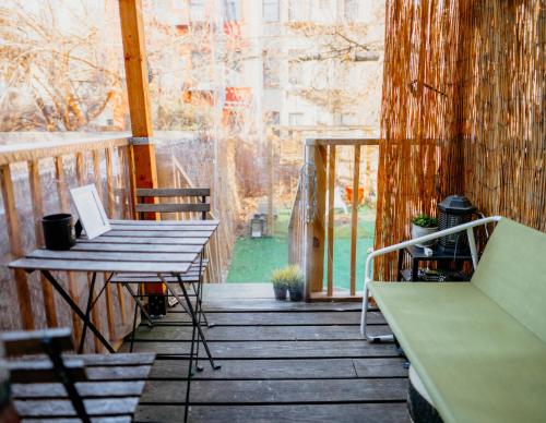 a porch with a table and a laptop on it at Private room with private bathroom and backyard in Brooklyn