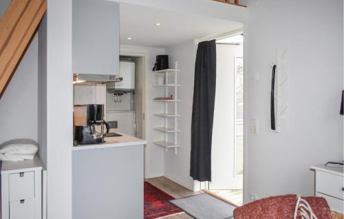 a small kitchen with white cabinets and a window at 1 Bedroom Amazing Home In Sölvesborg in Sölvesborg