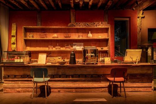 two chairs sitting in front of a counter in a room at Qushe Snowy Mountain View Art B&B in Lijiang