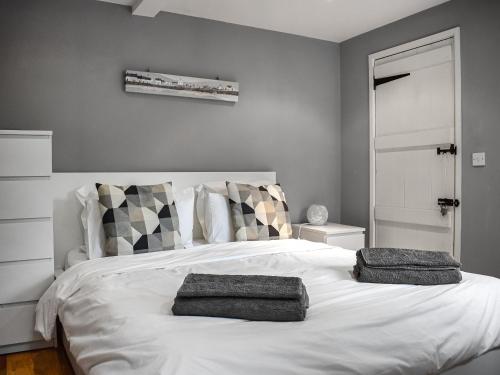 sypialnia z białym łóżkiem i 2 ręcznikami w obiekcie Uk46354 - Old Chimneys Cottage w mieście Wivelsfield Green