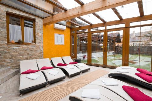 a room with four beds with red pillows at Hotel Maxant in Frymburk