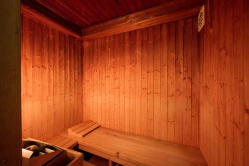 a wooden sauna with a bench in the corner at Hotel Maxant in Frymburk