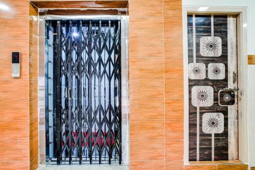 a black gate on the side of a building at Hotel O Aroma Classic Near Nampally Main Railway station in Hyderabad