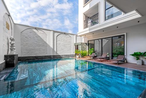 a swimming pool in the middle of a house at Le Cap Hotel & Apartment in Da Nang