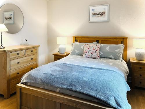 a bedroom with a bed with two night stands and two lamps at Portknockie Escape in Portknockie