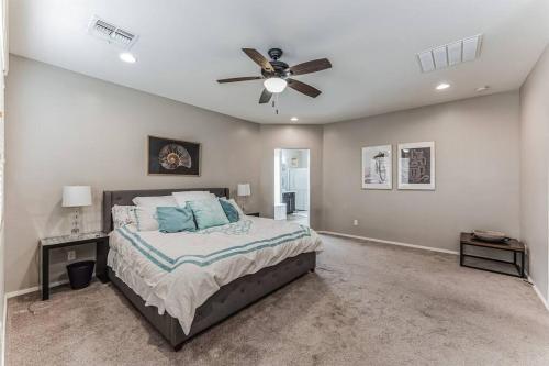 a bedroom with a bed and a ceiling fan at Beautiful 5BR, 3.5BA Home - Community Pool/Fitness in Gilbert