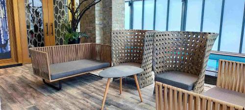 two chairs and a table on a balcony at Icloud Luxury Resort & Hotel in Taichung