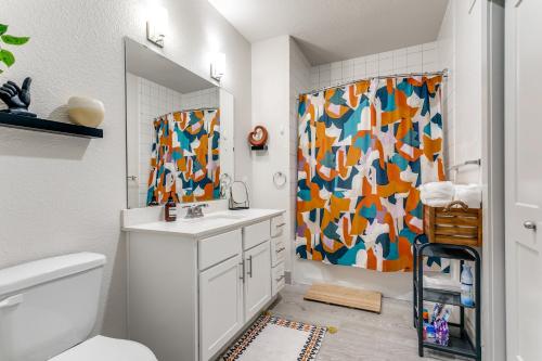 a bathroom with a sink and a shower curtain at Beautiful Riverwalk Condo #1535 in San Antonio