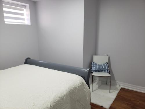 a bedroom with a bed and a chair at Luxurious 1BR-1BA Apartment Bright Spacious with free parking-gc-1 in Brampton