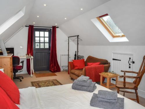 a room with a bed with red pillows on it at Old Chimneys Studio in Lewes