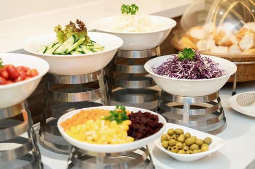 a display of bowls of different types of vegetables at Canary Dalat Hotel in Da Lat