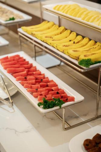 a buffet with many different types of food on trays at Canary Dalat Hotel in Da Lat