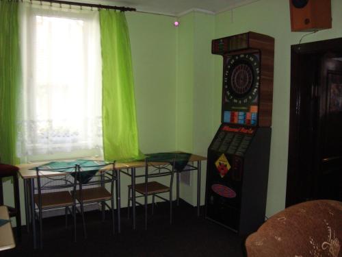 a room with a table and some chairs and a machine at Penzion Adria in Turčianske Teplice