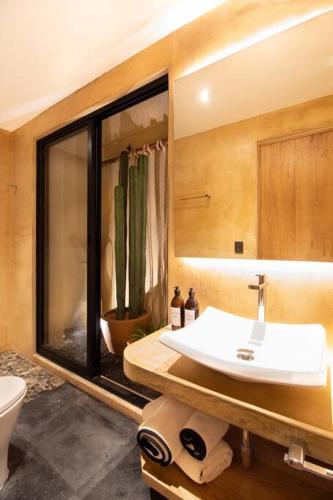 a bathroom with a sink and a mirror at Casa Rufina Oaxaca Centro - Adults Only in Oaxaca City