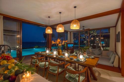 a dining room with a table and a view of the ocean at Fusion Resort Cam Ranh - All Spa Inclusive in Cam Ranh