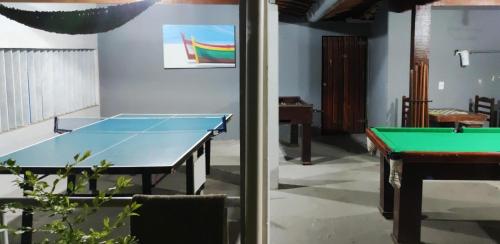 a pool table in a room with a ping pong ball at Pousada Estalagem dos Corais da Prainha in Arraial do Cabo