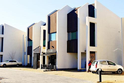a building with two cars parked in front of it at Jeju Sorang in Farms Village in Jeju