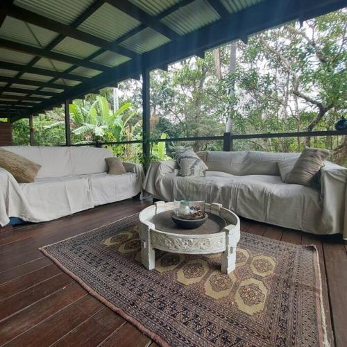 a living room with a couch and a coffee table at Dark Moon House in Yandina Creek