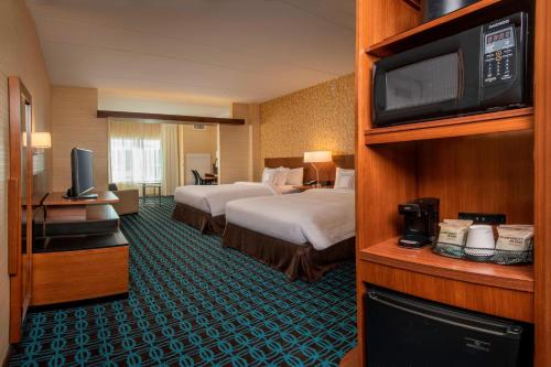 MiddletownにあるFairfield Inn & Suites by Marriott Harrisburg International Airportのベッド2台とテレビが備わるホテルルームです。