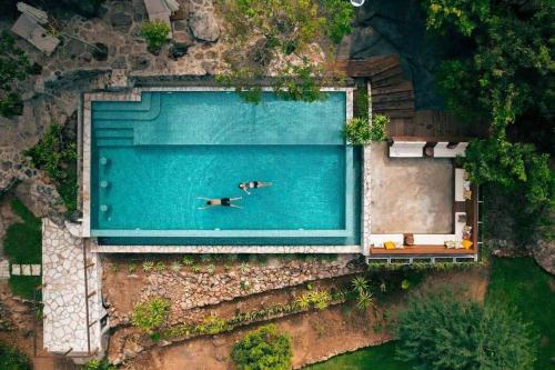 an overhead view of a pool with a person swimming at Kampot Trip 