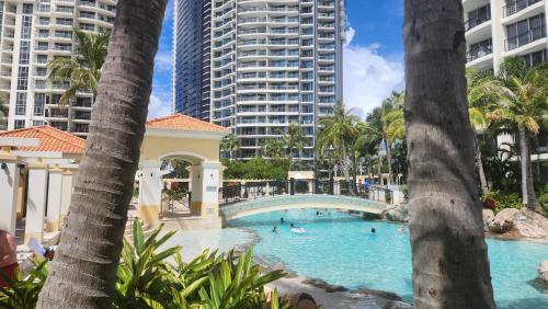 a swimming pool at a resort with tall buildings at Darren Surfers Apartment in Gold Coast