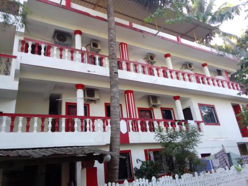 a building with red and white trim at Hotel Sea side in Calangute