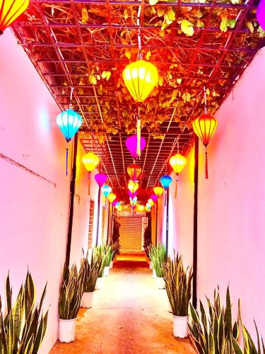 a hallway with colorful lights hanging from a ceiling at Muine Sports Hotel in Mui Ne