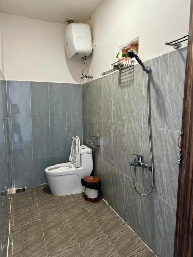 a bathroom with a toilet and a shower at Người Măng Đen Homestay in Kon Von Kla