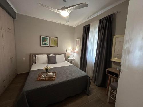 a hotel room with a bed with a tray on it at Karydakis Properties in Zakynthos Town