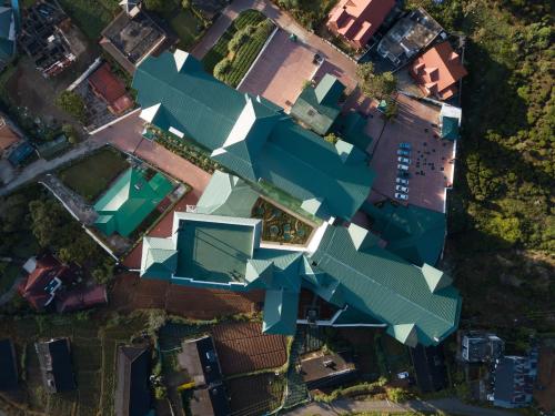 an overhead view of a house with blue roofs at Araliya Red - Budget friendly Hotel- Where you find stunning 360 panoramic view of Nuwara Eliya in Nuwara Eliya